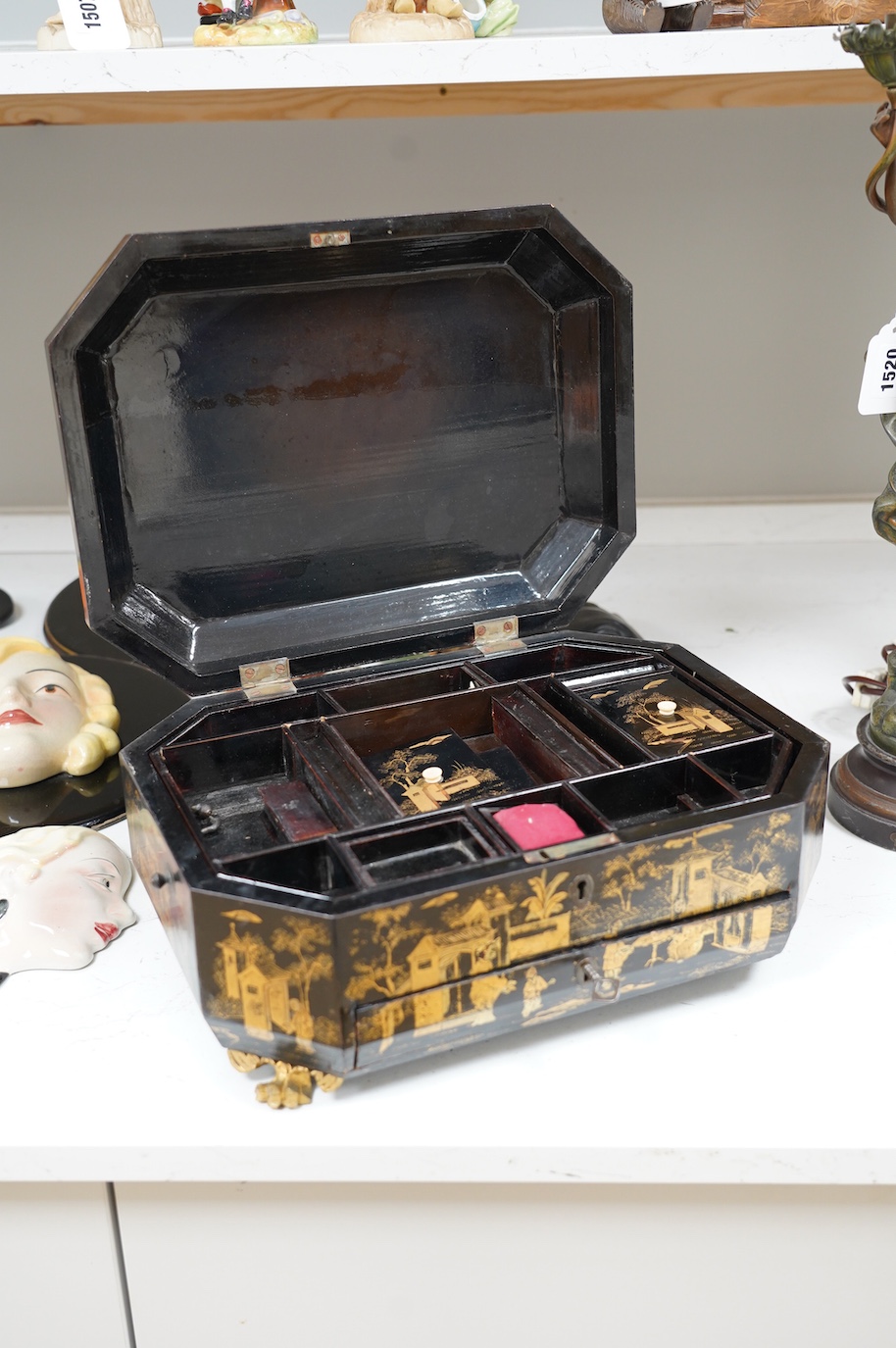 A Chinese black lacquer with gold decoration workbox, 36cm wide. Condition - one carved gilt paw foot missing to base